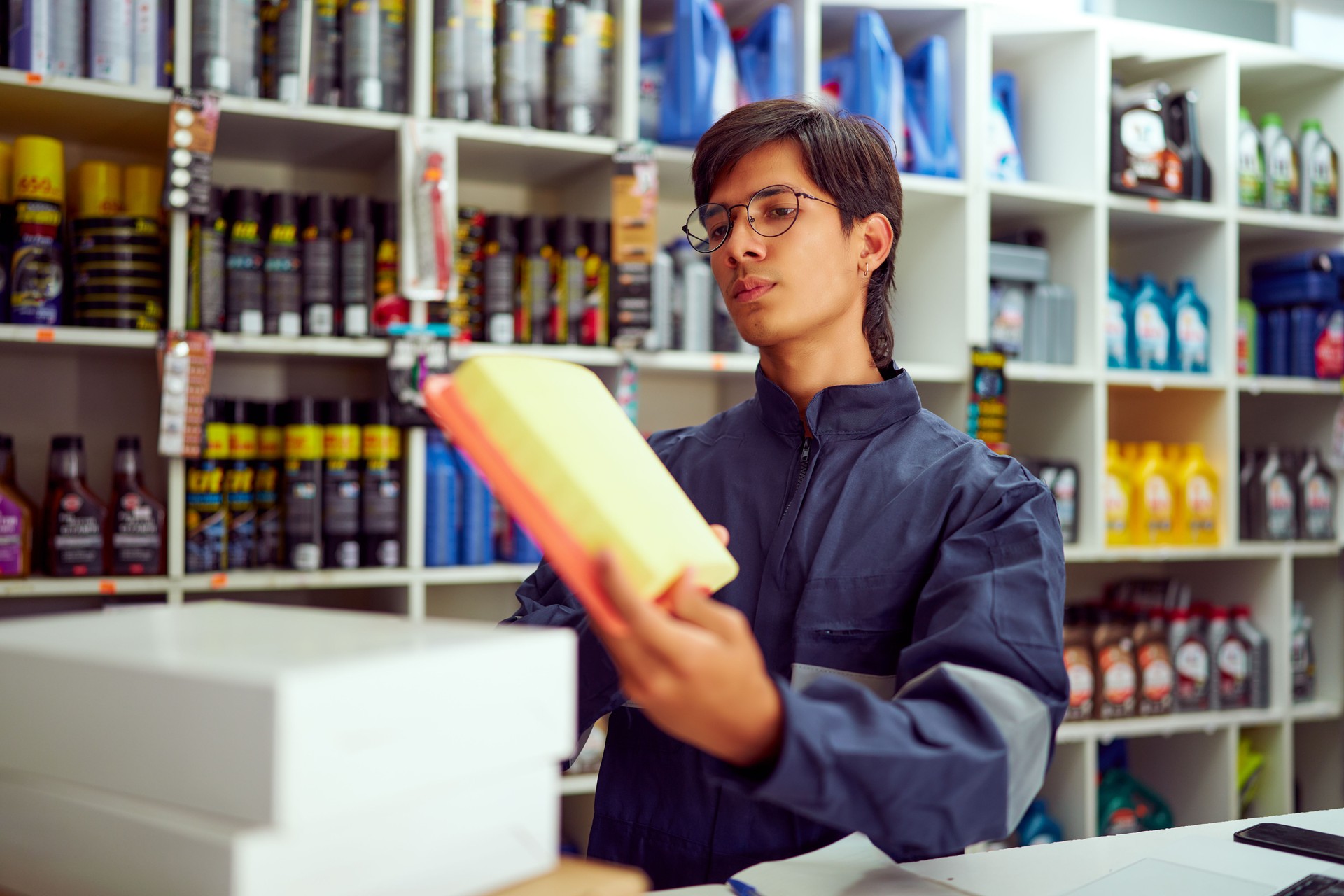 Mechanic holding new air filter in auto parts store